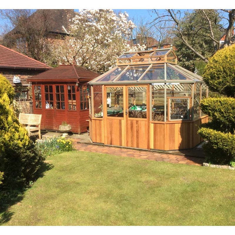 Alton Octagonal Cedar Greenhouse lifestyle image in back yard