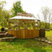 Alton Octagonal Cedar Greenhouse lifestyle image in woods