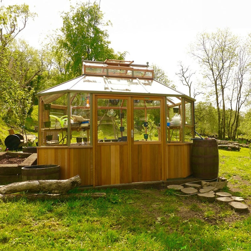 Alton Octagonal Cedar Greenhouse lifestyle image in woods