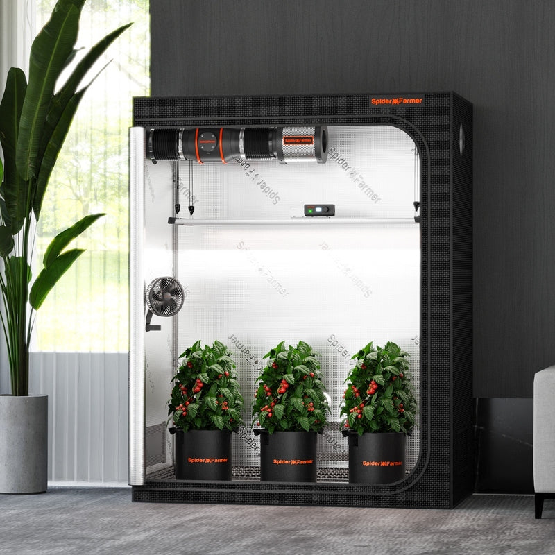 Spider Farmer® 4.6’x2.3’x6.5′ Grow Tent Black indoor gardening system with plants inside, placed in a room with a window and plant.
