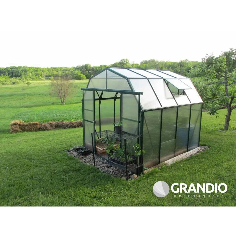 Grandio Elite Greenhouse 45 degree view shown with plants inside next to a field 