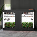 Spider Farmer 10’x5’x6.5′ Grow Tent Black indoor gardening system with plants inside, against a dark wall.