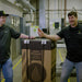 Two men in a warehouse setting with Anden AS150 Steam Humidifier packaged 