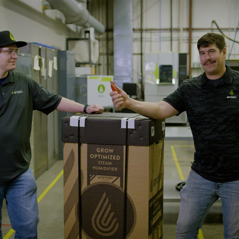 Two men in a warehouse setting with Anden AS150 Steam Humidifier packaged 