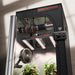Spider Farmer LED grow light with fan and plants on a neutral background