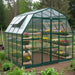 Grandio Summit Greenhouse with plants in a garden setting